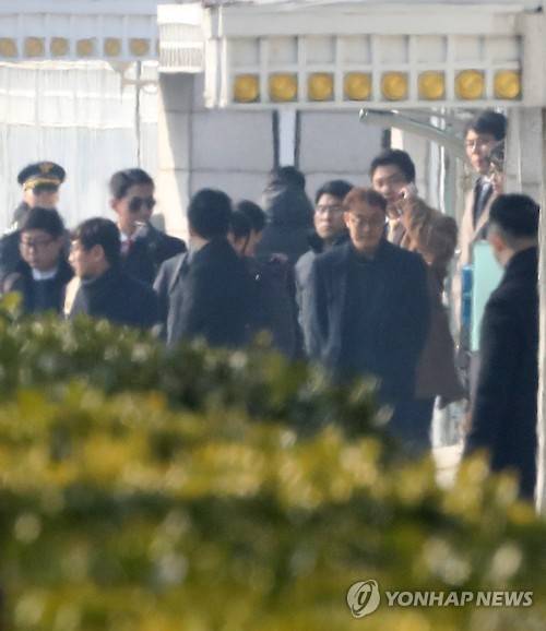 (서울=연합뉴스) 이상학 기자 = 청와대 압수수색에 나선 특검팀 관계자들이 3일 오후 청와대 연풍문 앞에 대기한 차량에 오르고 있다. 특검은 5시간에 걸친 대치 끝에 일단 철수하고 향후 재시도를 포함한 대응 방안을 검토하기로 했다. 오른쪽 황토색 코트는 홍정석 특검 부대변인.  2017.2.3      leesh@yna.co.kr