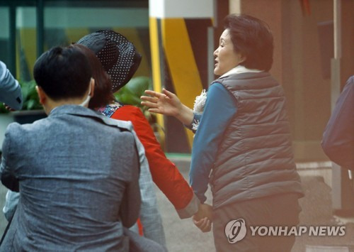 영부인 김정숙 여사가 자신의 집을 찾아온 민원인에게 라면을 먹고 가라며 손을 잡고 이끌고 있다. (사진=연합뉴스)