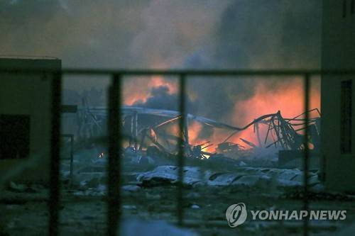 epa04881647 General view of the destruction after explosions in the port area of Tianjin, northern China, 13 August 2015. Official reports say at least 17 people were killed and hundreds injured. Thirty-two people were critically injured, and another 283 in hospital, after the blast and fireball in the port city of Tianjin. EPA/STR CHINA OUT