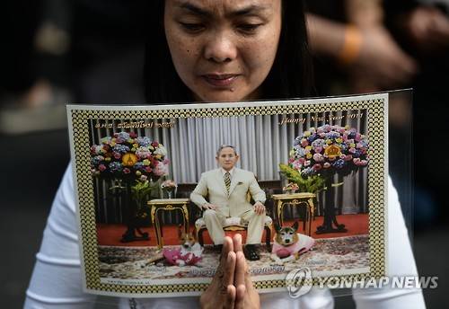 방콕 왕궁 앞에서 푸미폰 아둔야뎃 국왕을 추모하며 눈물을 흘리는현지 여성[AFP=연합뉴스]