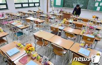 세월호 참사로 희생된 2학년 학생들이 사용한 교실을 임시 이전해 재현한 ‘단원고 416 기억교실’이 일반에 공개된 21일 오전 경기도 안산시 단원구 안산교육지원청 별관을 찾은 한 유가족이 책상 위에 올려진 방명록을 살펴보고 있다.  © News1 이재명 기자