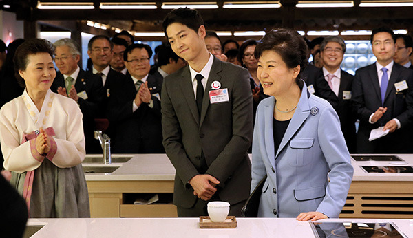 ⓒ연합뉴스 4월11일 서울 한식문화관에서 열린 K스타일허브 한식문화관 개관식에 참석한 박근혜 대통령과 배우 송중기씨 그리고 윤숙자 한식재단 이사장(오른쪽부터).