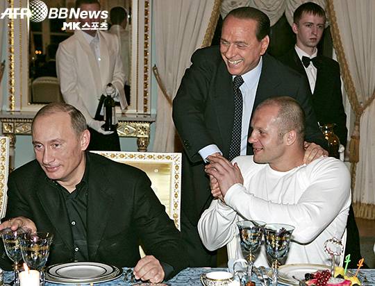 표도르 예멜리야넨코(오른쪽)가 실비오 베를루스코니(가운데) 전 이탈리아 총리와 악수하고 있다. 왼쪽은 블라디미르 푸틴 러시아 대통령. 사진(러시아 상트페테르부르크)=AFPBBNews=News1