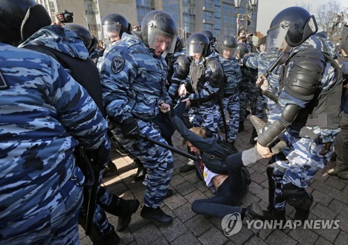 러시아 시위진압부대 요원들이 26일(현지시간) 모스크바 시내에서 시위 참가자들을 연행하고 있다. [EPA=연합뉴스]