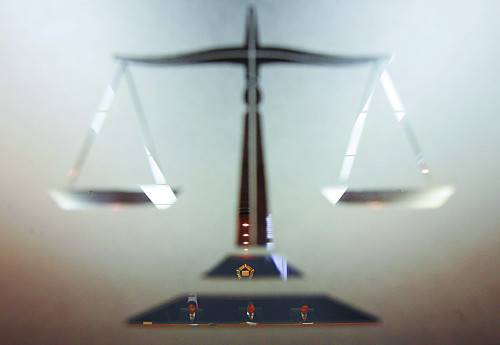 만인을 위한 정의와 공평을 상징하는 저울이 새겨진 창을 통해 들여다 본 법정 모습. 국민일보DB