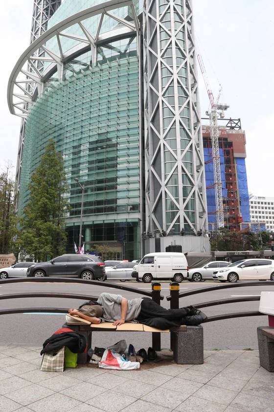 점심시간 종각역 4거리 벤치에서 한 노숙인이 잠을 자고 있다.