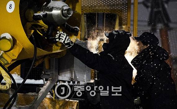 제설작업에 나선 슬로프 관리 직원들이 제설기를 이동 시키고 있다.