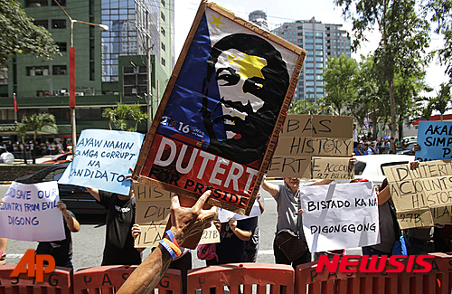【마닐라=AP/뉴시스】필리핀 마닐라에서 2일 한 남성이 로드리고 두테르테 후보의 포스터를 들고 지지 시위를 벌이고 있다. 2016.05.03