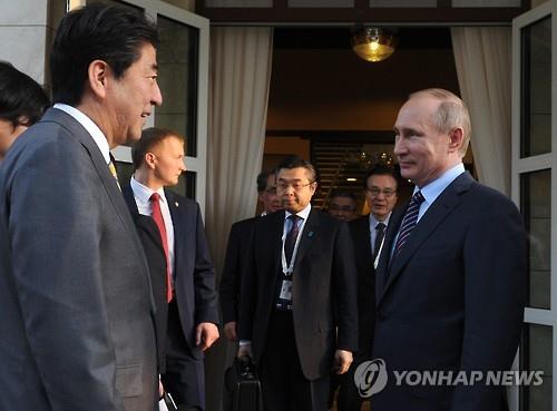 블라디미르 푸틴 러시아 대통령(오른쪽)이 6일 러시아 남부도시 소치를 방문한 아베 신조(安倍晋三) 일본 총리를 맞이하고 있다. [EPA=연합뉴스]