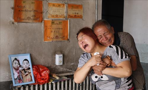 중국 허베이성 징싱현을 덮친 폭우로 자식을 잃은 여성이 오열을 하고 있다. 징싱현에서만 36명이 사망했고 35명의 생사가 여전히 확인되지 않다.[봉황망 캡처]