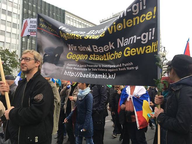 8일 독일 베를린에서 열린 반전 시위에 한국 교민들이 ‘우리는 백남기(농민)에 대한 국가폭력을 반대한다’고 적힌 팻말을 들고 행진하고 있다. 한주연 통신원
