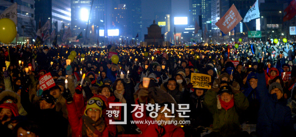 시민들이 21일 많은 눈에도 불구하고 서울 광화문광장에서 열린 촛불집회에 참석하고 있다. 이석우 기자 foto0307@kyunghyang.com
