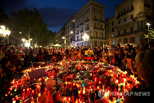 (바르셀로나 AP=연합뉴스) 18일(현지시간) 스페인 바르셀로나 람블라스 거리에 수많은 촛불과 꽃들이 놓여 있는 가운데 추모객들이 전날 이곳에서 일어난 차량 테러 희생자들을 기리고 있다.       lkm@yna.co.kr