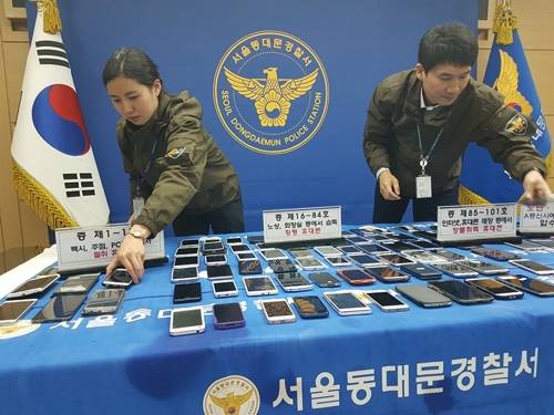 서울 동대문경찰서가 도난·분실 신고된 휴대전화들을 추적한 결과 총 282명을 적발했다. 사진은 경찰관들이 압수된 휴대전화들을 정리하는 모습. [동대문경찰서 제공=연합뉴스]