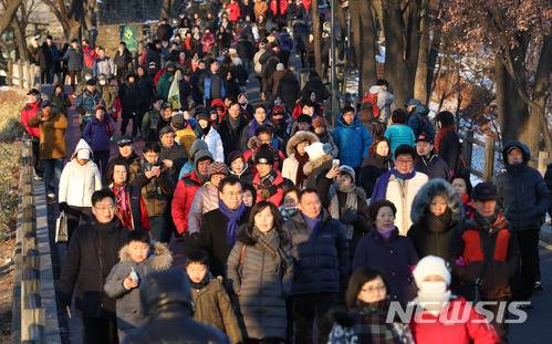 【서울=뉴시스】김선웅 기자 = 2018 무술년 첫 날인 1일 오전 서울 중구 남산공원에서 해맞이객들이 올해 첫일출을 맞이한 후 하산하고 있다. 2018.01.01. mangusta@newsis.com
