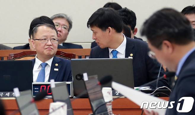 한승희 국세청장(왼쪽)과 김영문 관세청장이 2일 서울 여의도 국회 본청에서 열린 기획재정위원회 전체회의에 출석해 대화를 나누고 있다. 2018.2.2/뉴스1 © News1 이동원 기자