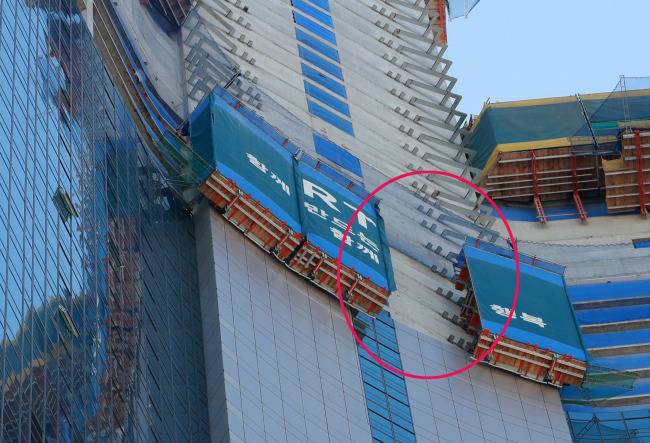 2일 오후 2시께 부산 해운대 엘시티 공사현장 55층 외벽에 설치된 안전시설물이 내부에서 일하던 근로자 3명과 함께 바닥으로 추락했다. 원내 사진은 사고가 발생한 안전시설물 모습. [사진=연합뉴스]