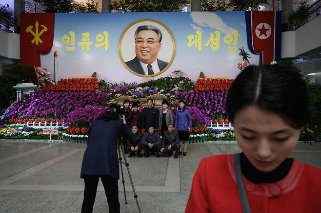 북한 시민들이 지난 13일 '김일성화축전' 열린 김일성화김정일화전시관에서 사진을 찍고 있다. [AFP=연합뉴스]