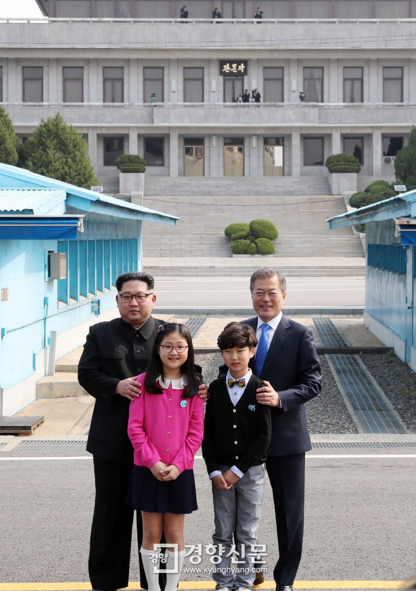 문재인 대통령과 김정은 북한 국무위원장이 27일 남북정상회담에서 화동들의 꽃다발을 받은 뒤 판문점 자유의 집 앞에서 기념촬영을 하고 있다.  한국공동사진기자단 서성일 기자