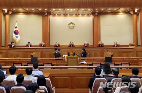 【서울=뉴시스】임태훈 기자 = 이진성 헌법재판소장을 비롯한 헌법재판관들이 28일 오후 서울 종로구 재동 헌법재판소 대심판정에서 열린 6월 심판사건 선고를 위해 자리에 앉아 있다. 2018.06.28.   taehoonlim@newsis.com