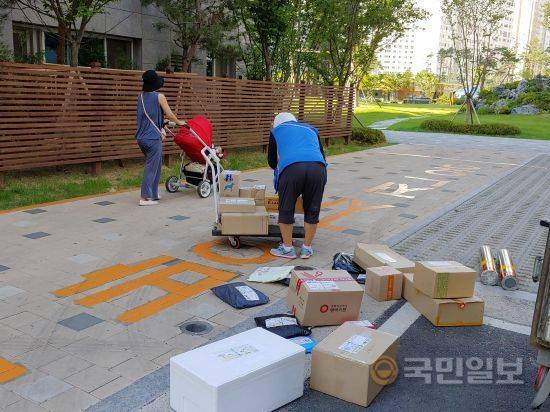 A씨가 택배를 손수레에 싣고 있다.