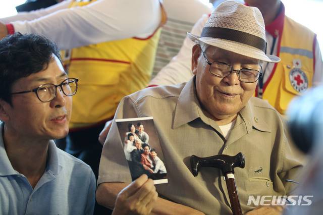 【속초=뉴시스】김진아 기자 = 21차 이산가족 상봉을 하루 앞둔 19일 오후 강원도 속초 한화리조트에서 남측 1차 상봉 대상자인 유관식(89) 할아버지와 가족들이 인터뷰 중 가족사진을 보여주고 있다. 유 할아버지는 4촌과 딸을 만날 예정이다.  2년10개월 만에 열리는 이번 이산가족 상봉 행사에는 이산가족 89명과 동반가족 108명 등 총 197명이 20일부터 22일까지 열리는 '1차 이산가족 상봉행사'에 참여할 예정이다. 2018.08.19. bluesoda@newsis.com