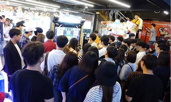 (홍대 짱 오락실의 모습. 과거 DDR 시절처럼 수많은 인파가 구경을 하고 있다)