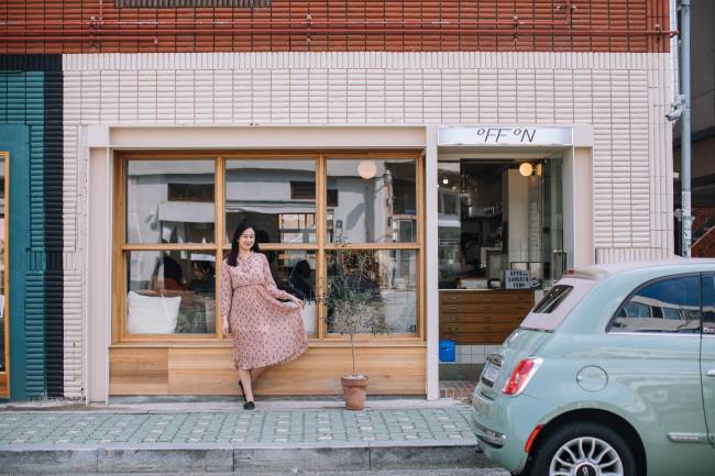A woman poses outside a shop on Busan’s trendy street Haeridan-gil. / Paradise Hotel Busan