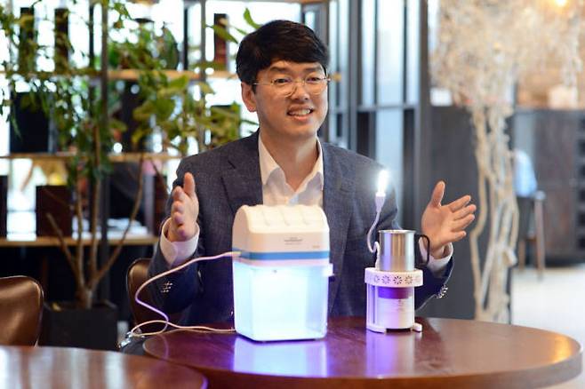 박은현 쉐어라이트 대표가 촛불의 열 에너지로도 LED 조명을 켤 수 있는 쉐어라이팅(오른쪽), 수동으로 전력을 생산해 UVC LED 물 살균을 할 수 있는 퓨리라이트를 소개하고 있다.