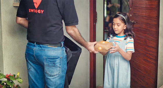 인도 1위 배달 대행업체 ‘스위기’(Swiggy)의 배달원이 가정집을 방문해 소녀에게 주문한 음식을 전해주고 있다. 현재 인도 패스트푸드 업계 매출의 4분의 1이 배달 앱에서 발생할 만큼 인도 온라인 배달 시장이 급성장하고 있다. /스위기(Swiggy)