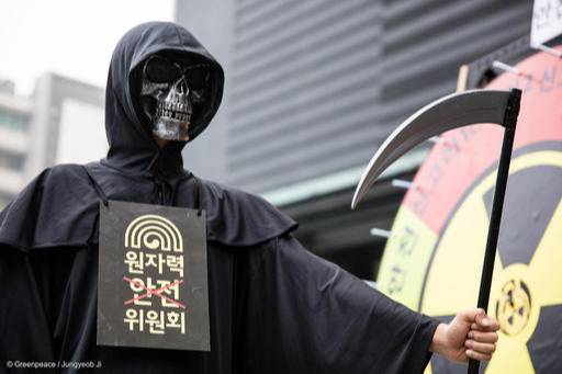 2016년 5월 26일&nbsp;원자력안전위원회가 위치한 서울 종로구 KT빌딩 앞에서&nbsp;‘죽음의 신’으로 분장한 그린피스 운동가가&nbsp;‘안전 복불복’이라고 이름 붙은 대형 돌림판을 앞에서 원전 반대 퍼포먼스를 하고 있다. 그린피스 제공