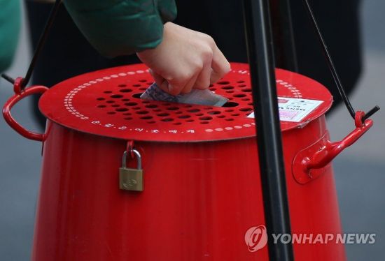 한 시민이 구세군 자선냄비에 기부하고 있다. [이미지출처=연합뉴스]