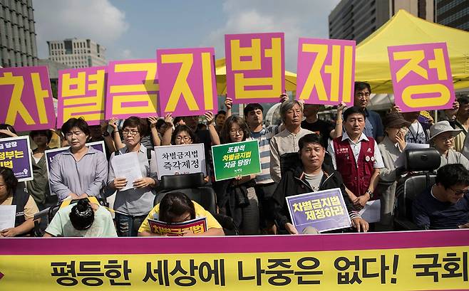 ⓒ연합뉴스2017년 9월12일 차별금지법 제정 촉구 기자회견에서 참석자들이 관련 내용이 적힌 피켓을 들고 있다.