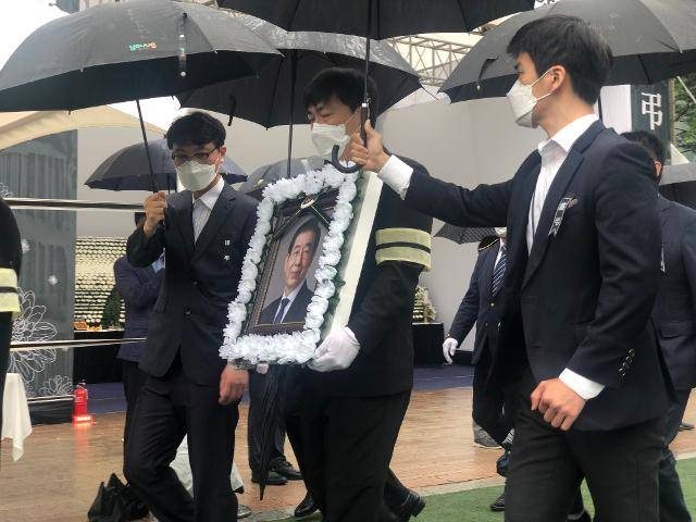 13일 오전 서울시청 앞 광장에서 박원순 서울시장의 유족이 박 시장의 영정을 품에 안고 이동하고 있다. 이승엽 기자