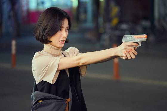 Eun-young holds out the BB Gun for protection. [NETFLIX]