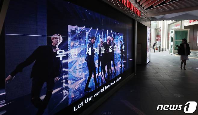 서울 중구 롯데면세점에 BTS의 광고판 앞으로 한 시민들이 지나고 있다. 2020.9.8/뉴스1 © News1 김진환 기자