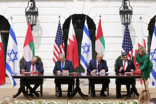 도널드 트럼프 미국 대통령이 이스라엘과 아랍에미리트(UAE)를 포함한 중동국가 수뇌부들과 함께 평화협정에 서명하고 있다. 게티이미지