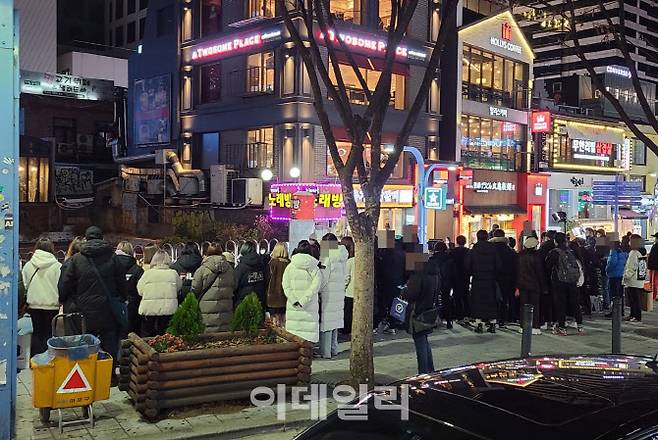 거리두기 2단계 시행을 앞둔 23일 밤 서울 마포구 홍대입구 인근 버스킹 공연을 사람들이 구경하고 있다.(사진=이용성 기자)