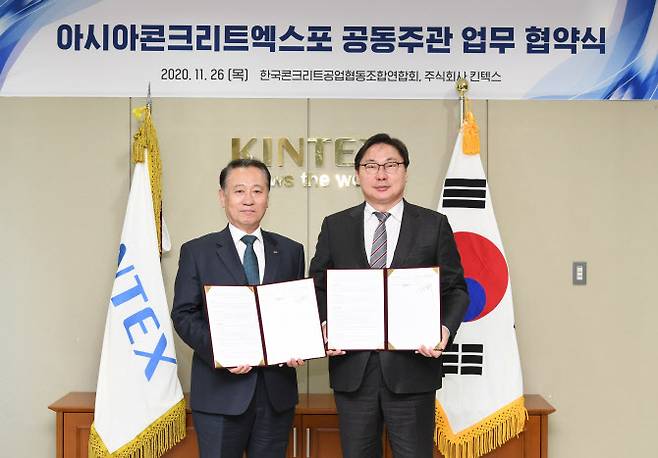 이화영 대표이사(오른쪽)와 김동우 회장이 협약서를 들어보이고 있다.(사진=킨텍스 제공)