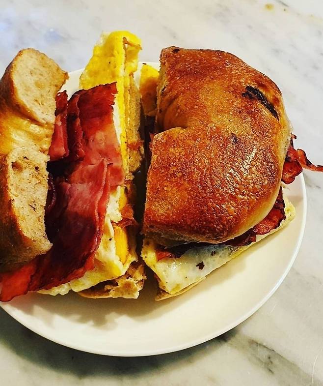 Lots O Bagels’ egg sandwich features egg, bacon and melted cheese. (Photo credit: New York Lots O Bagels)