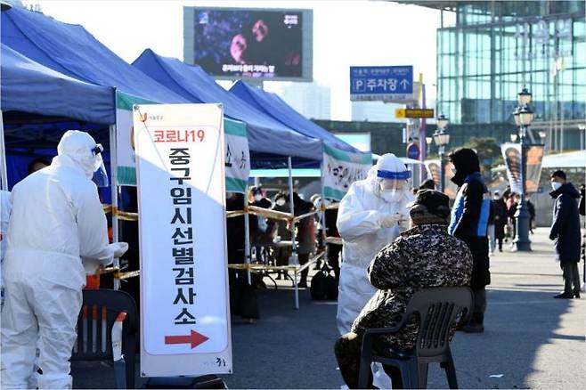 정부가 코로나19 확산에 대응해 대규모 선제 진단검사를 실시하기 위해 수도권 150여곳에 임시선별진료소 운영을 시작한 14일 오전 서울역 광장에 마련된 중구 임시선별진료소에서 시민들이 검사를 받고 있다. 황진환기자