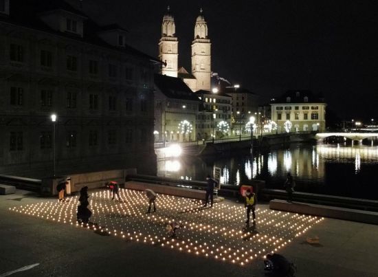 스위스 취리히의 다리 위에서 지난달 30일(현지시간) 시민들이 신종 코로나바이러스 감염증(코로나19) 희생자 추모 집회를 위한 촛불을 켜고 있다. [이미지출처=로이터연합뉴스]