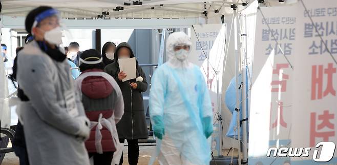 지난달 21일 오전 부산 부산진구 놀이마루 운동장에 마련된 코로나19 임시 선별진료소를 찾은 시민들이 코로나19 검사를 받고 있다. 2020.12.21/뉴스1 © News1 여주연 기자
