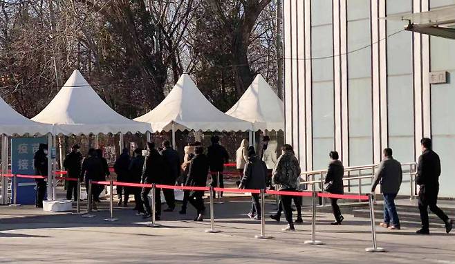 지난 4일 중국 베이징 차오양구에서 코로나19 백신 접종 희망자들이 접종 장소로 들어가고 있다. (사진=연합뉴스)