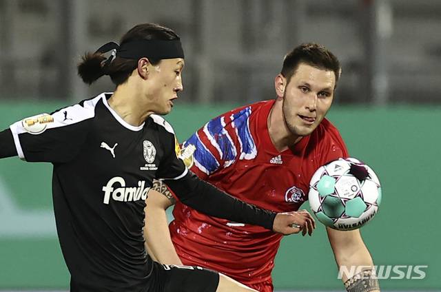 [킬=AP/뉴시스]홀슈타인 킬의 이재성(왼쪽)이 13일(현지시간) 독일 킬의 홀슈타인 경기장에서 열린 2020~2021시즌 독일축구협회(DFB) 포칼 2라운드(32강) 바이에른 뮌헨과의 경기에 선발 출전해 공을 다투고 있다. 이재성은 2-2 연장 끝 승부차기에 4번째 키커로 나서 득점했고 킬은 6-5로 승리해 16강에 올랐다. 2021.01.14.