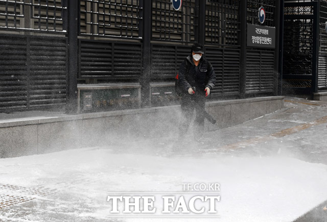 전국적으로 눈이 내리는 18일 오전 서울 종로구 광화문일대에서 정부청사 직원이 송풍기로 제설을 하고 있다. /임세준 기자