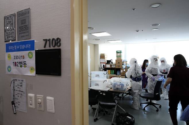 Nurses put on protective gear and prepare to care for COVID-19 patients.