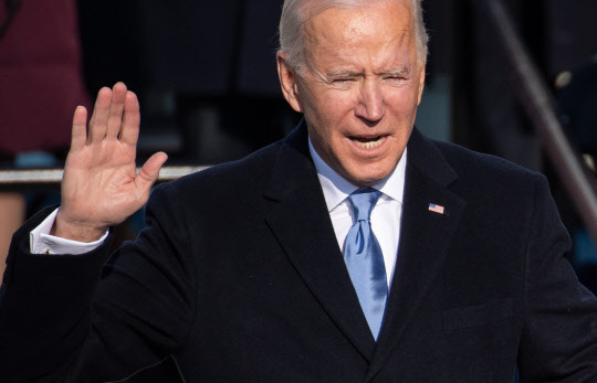 US President Joe Biden takes his oath of office while being sworn in as the 46th US President on January 20, 2021 at the US Capitol in Washington, DC.  Pool Photo by Saul Loeb/UPI