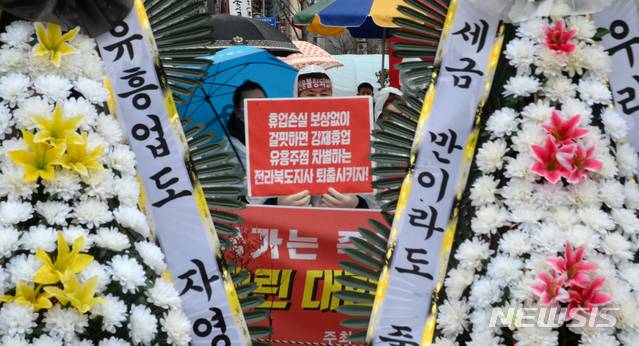 [전주=뉴시스] 김얼 기자 = 한국유흥·단란음식업중앙회전북지회 관계자들이 21일 전북 전주시 전북도청 앞에서 '유흥·단란주점 굶겨 죽이는 집합금지 중단조치 촉구 기자회견'을 열고 구호를 외치고 있다. 2021.01.21.pmkeul@newsis.com