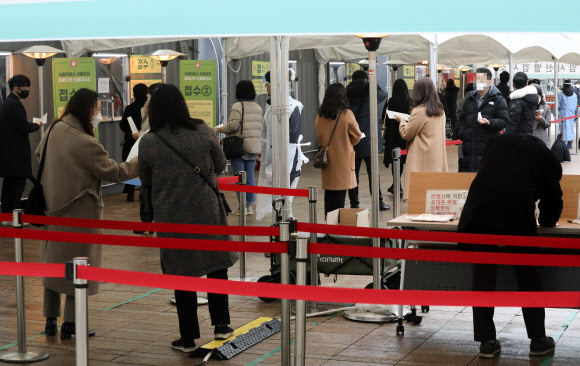 지난 22일 오전 중구 서울광장에 마련된 중구임시선별검사소에서 사람들이 코로나19 검사를 받기 위해 줄지어 대기하고 있다. 뉴시스